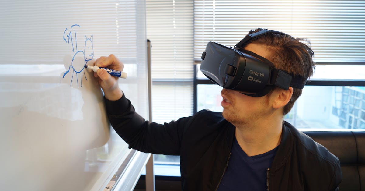 A man wearing a VR headset drawing a cat on a whiteboard in an office environment.